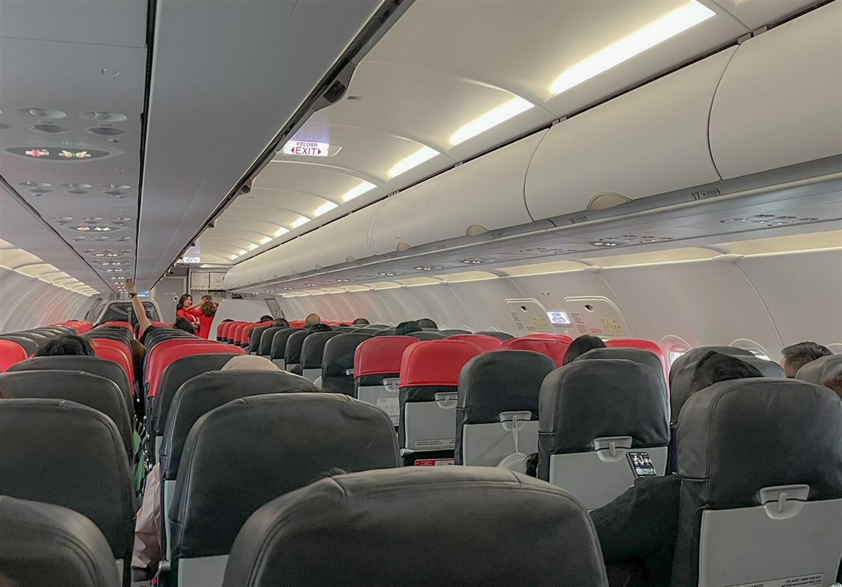 AirAsia economy cabin with red and black seats in a 3-3 layout