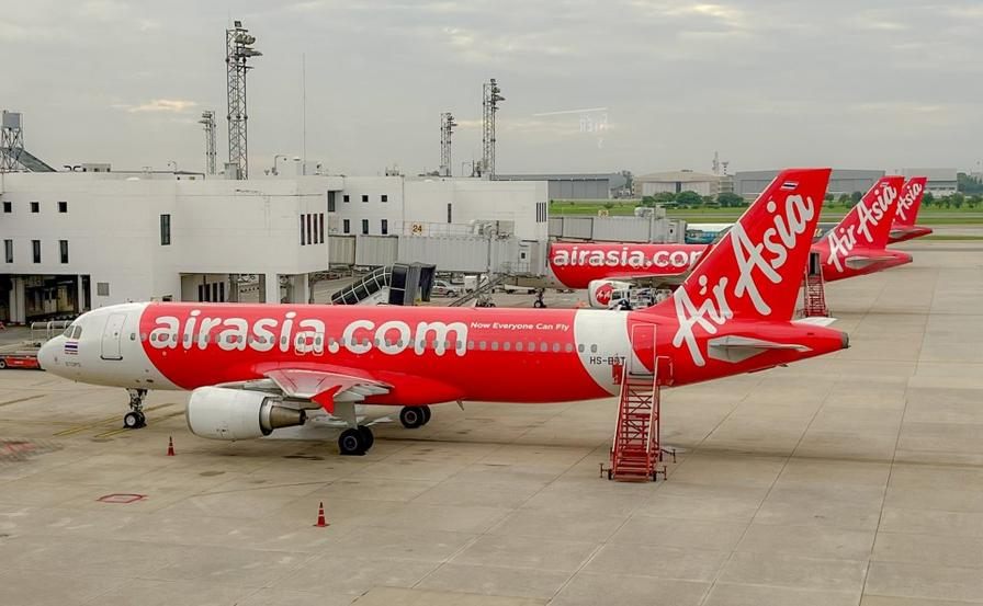 Red AirAsia Airbus fleet parked at the airport apron
